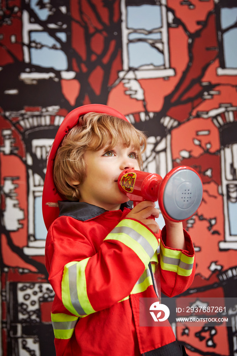 Portrait of boy in fire fighter costume (4-5)