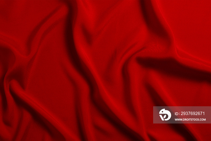 Red silk or satin luxury fabric texture can use as abstract background. Top view.