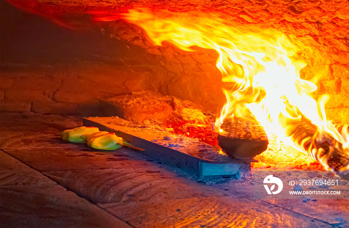 Traditional brick pita oven, burning wood and flames