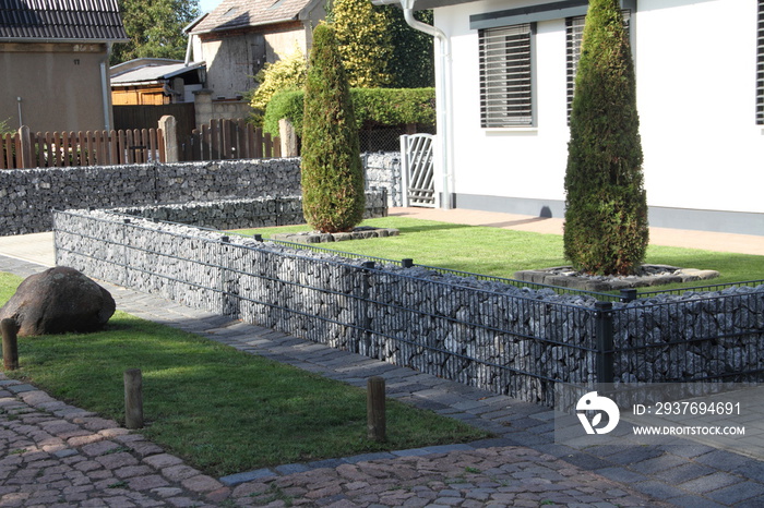 a new house with gabions as a fence