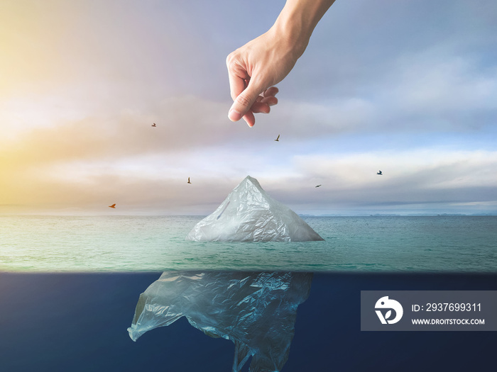 Hand throwing plastic bag floating in ocean, environment pollution