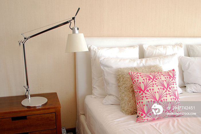 Night table and pillows on bed in bedroom; Argentina