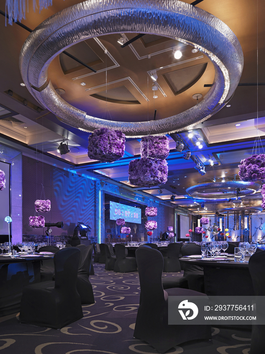 Purple decor hanging in dining area of modern restaurant