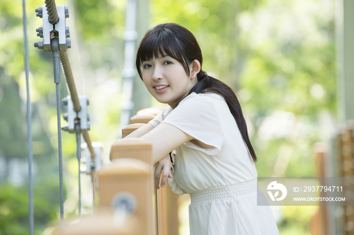 Young woman standing on bridge