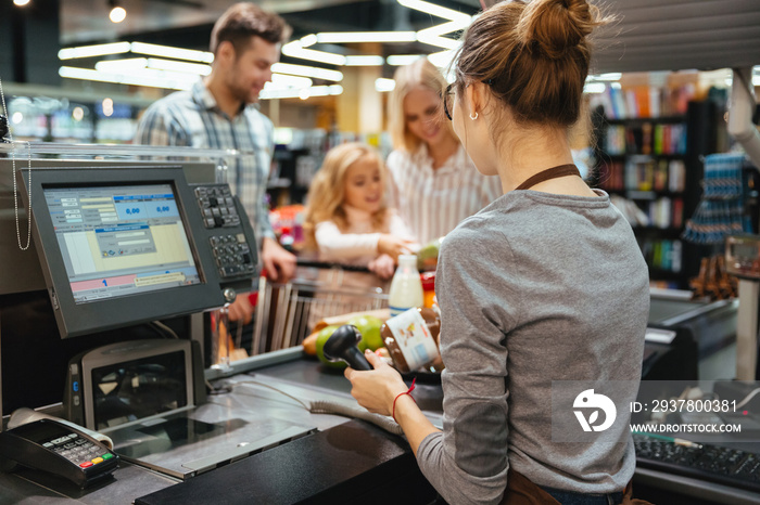 Beautiful family standing at the cash counter