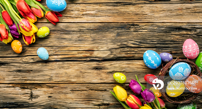 Easter eggs and tulips on wooden planks