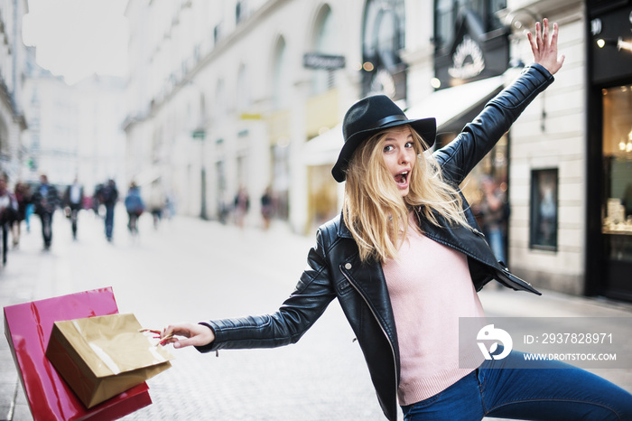 a young trendy woman doing shopping in the city expresses its j