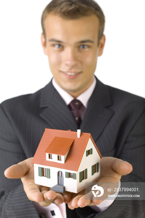 Young businessman with house