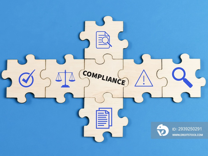 Compliance concept on jigsaw puzzle pieces with icons against blue background.